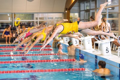 Students diving into the pool for a House swimming race.