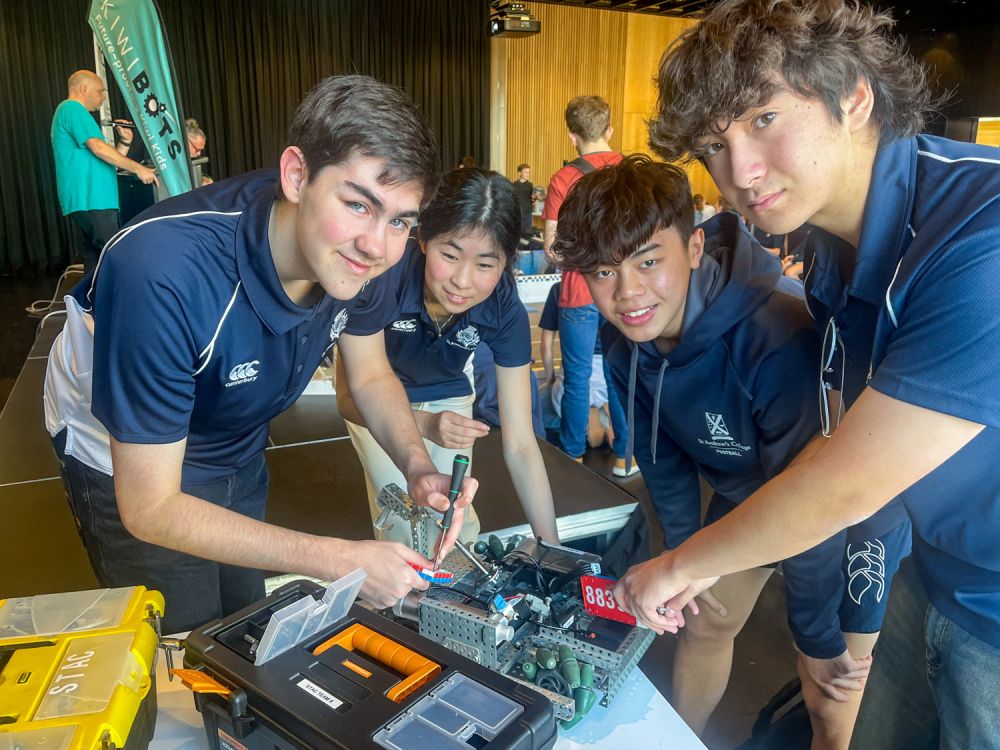 Four St Andrew's College students working on their robot at the VEX Canterbury Challenge.