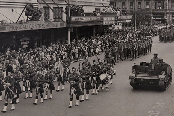 StAC Pipe Band in a town parade between 1937-1946