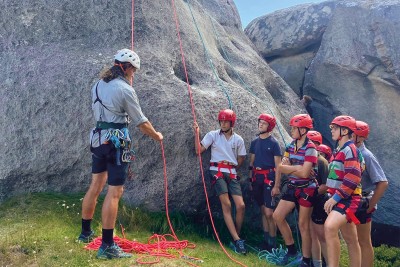 Boarders listening to abseiling instructor.