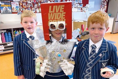 Students dressed in their creative project made from pre-used materials.