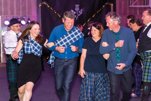 Ceilidh attendees participating in dancing at the event.
