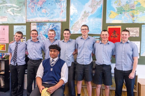 Back: William Martin, Samuel Richardson, William Gibson, Connor Frew, Theo Thomas, James Walker, Luke Watson (all Year 11), with their barber, Michael Vaivai (Year 12), seated in front.