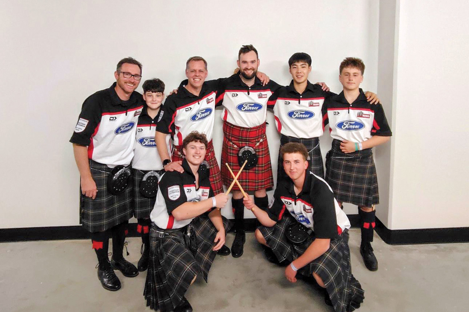 St Andrew's College Pipe Band members and tutors at Te Kaha