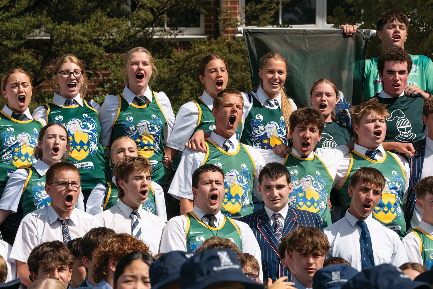St Andrew's College students cheering dressed in Thompson House colours at the annual Highland Games.