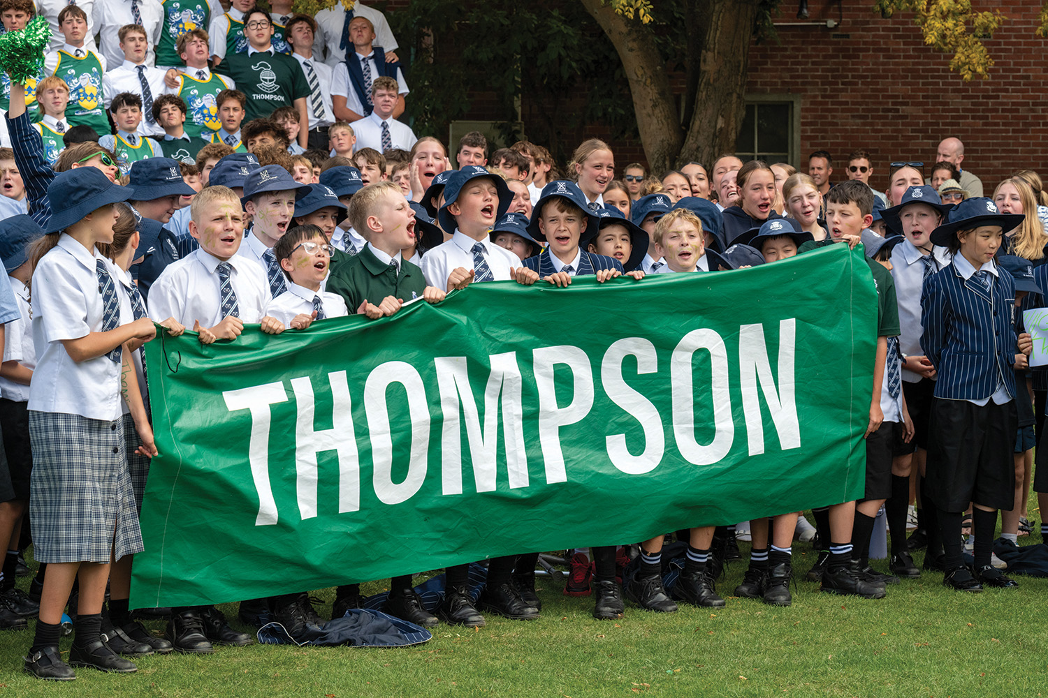 St Andrew's College students cheering dressed in Thompson House colours at the annual Highland Games.