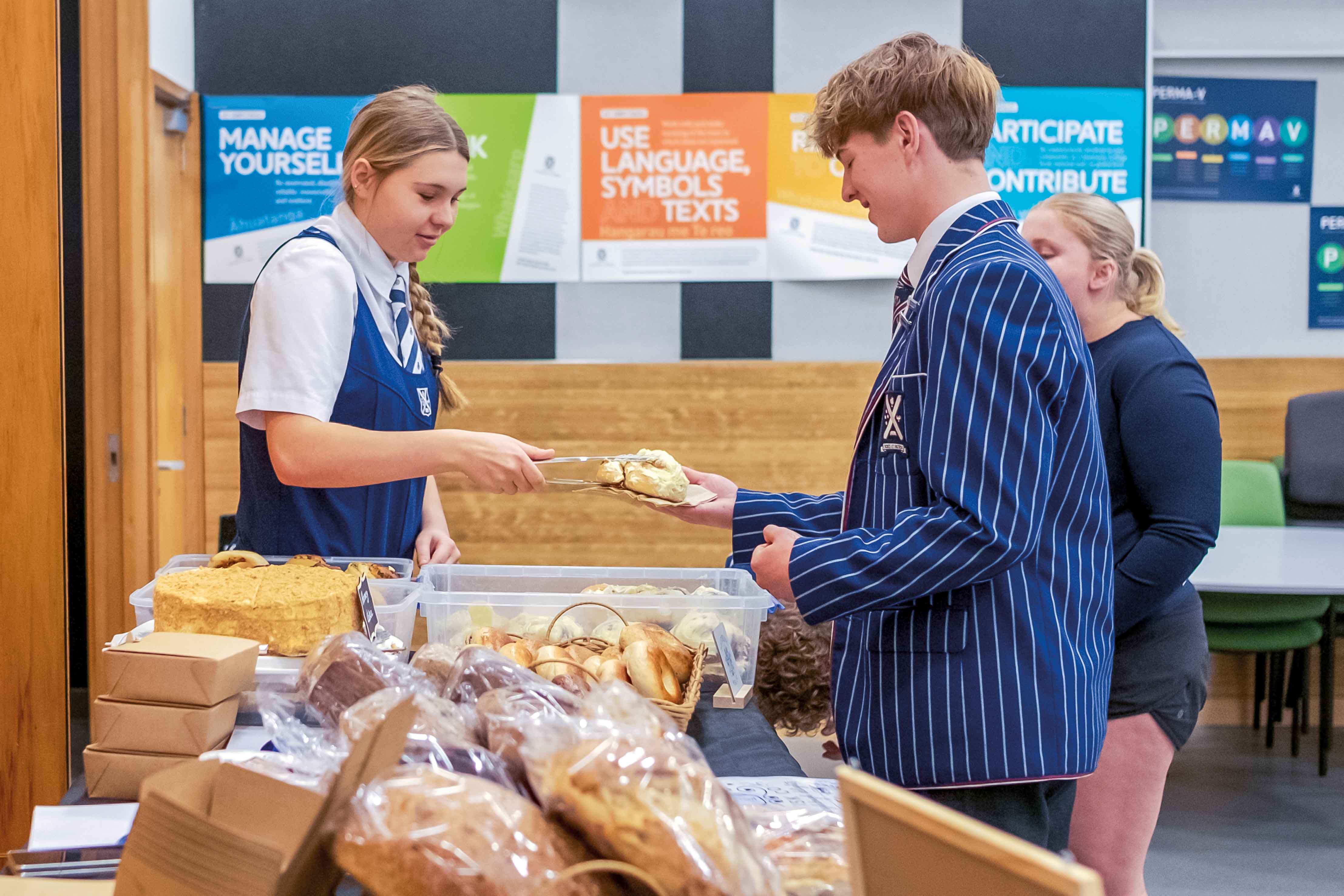 St Andrew's College student serving customers at her stall at the Business Studies Night Market.