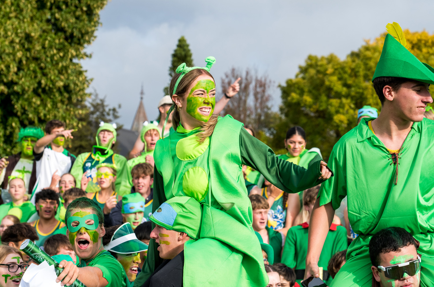 St Andrew's College Secondary School students chanting dressed in green at the Athletics Sports Day.