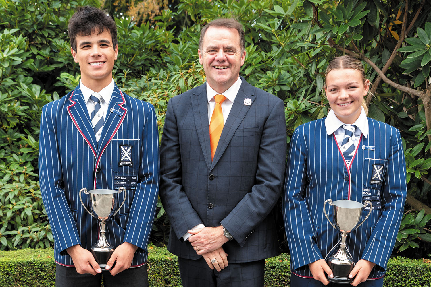 Robert Burns Scholars, Tom Simpson and Lila Waghorn, with St Andrew's College Rector, Mark Wilson.