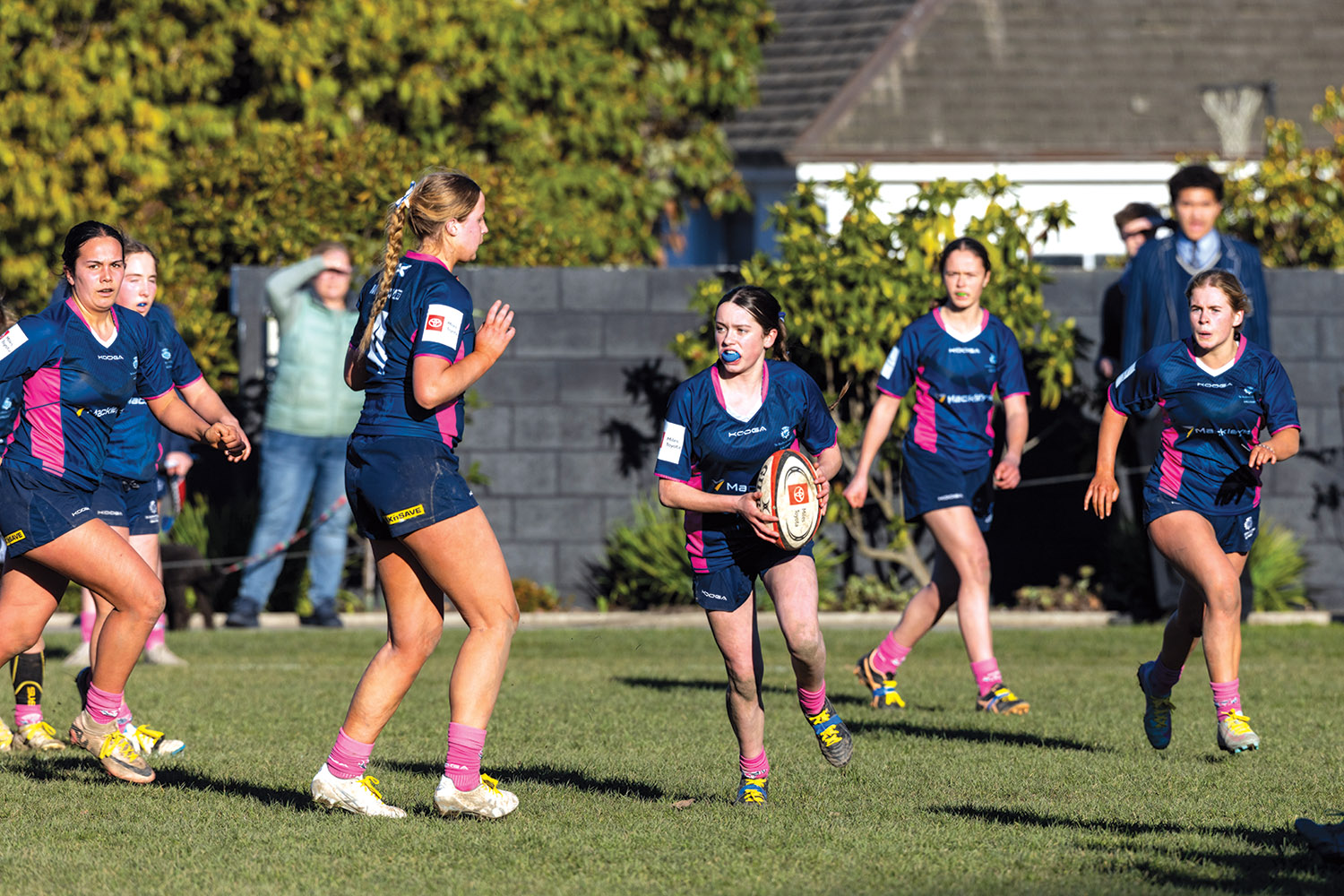 St Andrew's College female students playing rugby