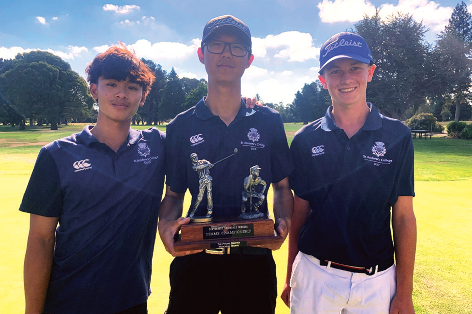 Three St Andrew's College students with their Canterbury Team's Golf Championship trophy