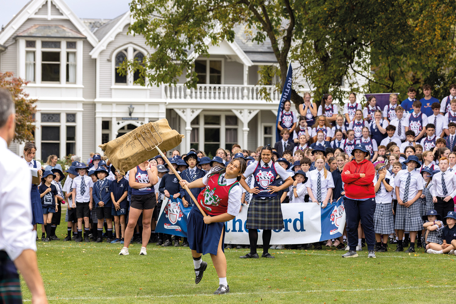 St Andrew's College student competing in wheat sheaf tossing at the 2026 Highland Games