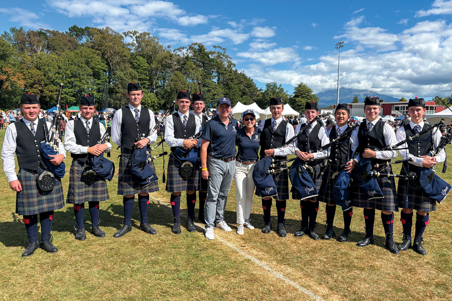 St Andrew's College Pipe Band members with Rector Mark Wilson and his wife Judi.