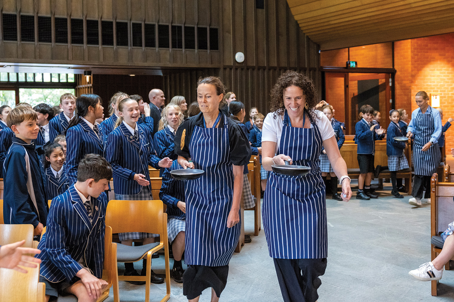 St Andrew's College Preparatory School teachers competing at the annual Shrove Tuesday pancake race.