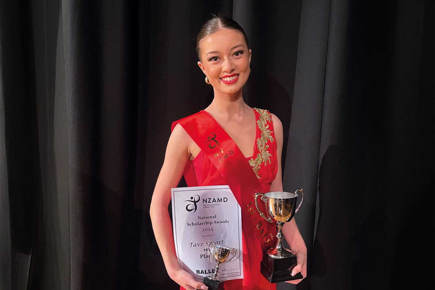 St Andrew's College student, Tave Stuart, holding the National Ballet Scholarship award.