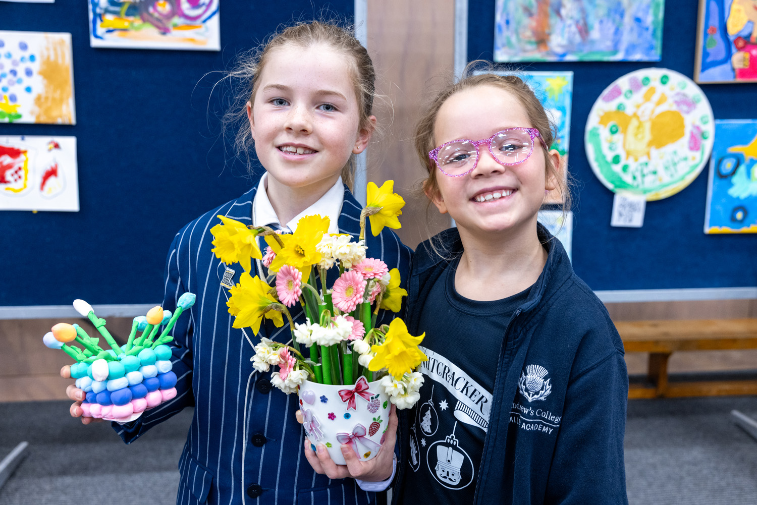 Two St Andrew's College students holding their flower arrangements at the 2025 StAC Ag Show.