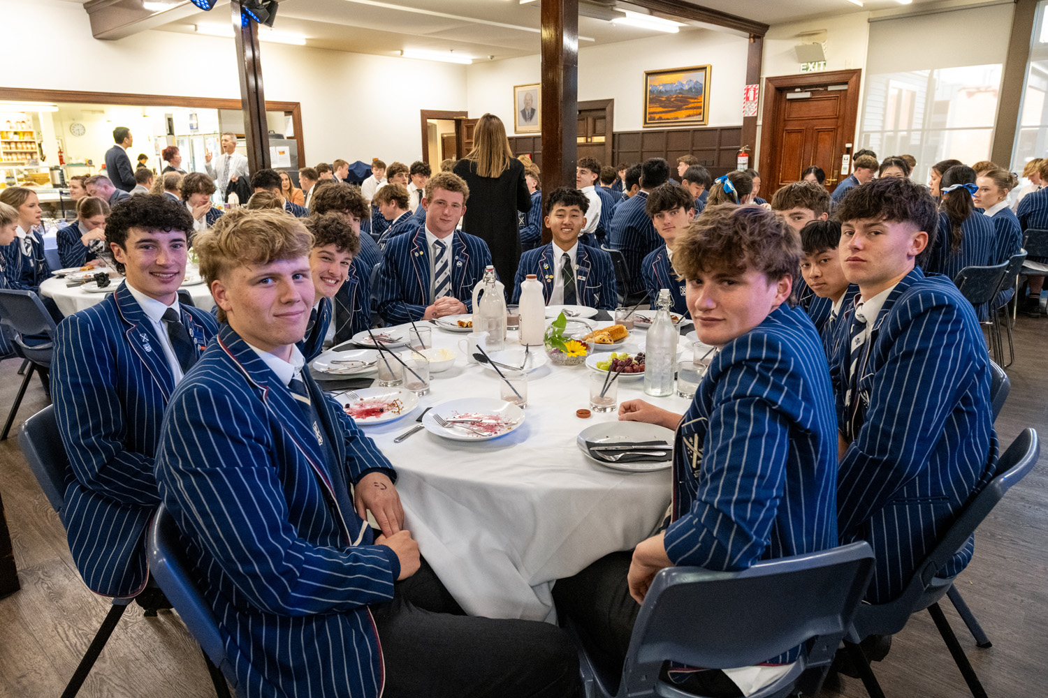 A group of St Andrew's College students sitting at a table at the 2025 Leavers' Breakfast.