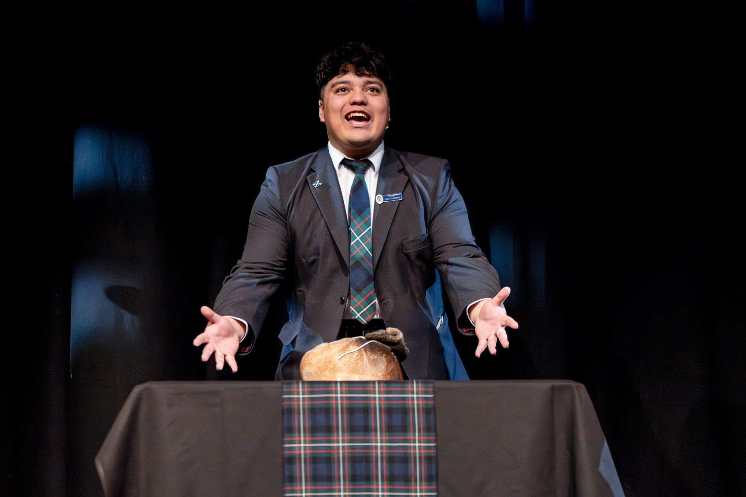 St Andrew's College student performing 'Address to a Haggis' at StAC Attack 2025.