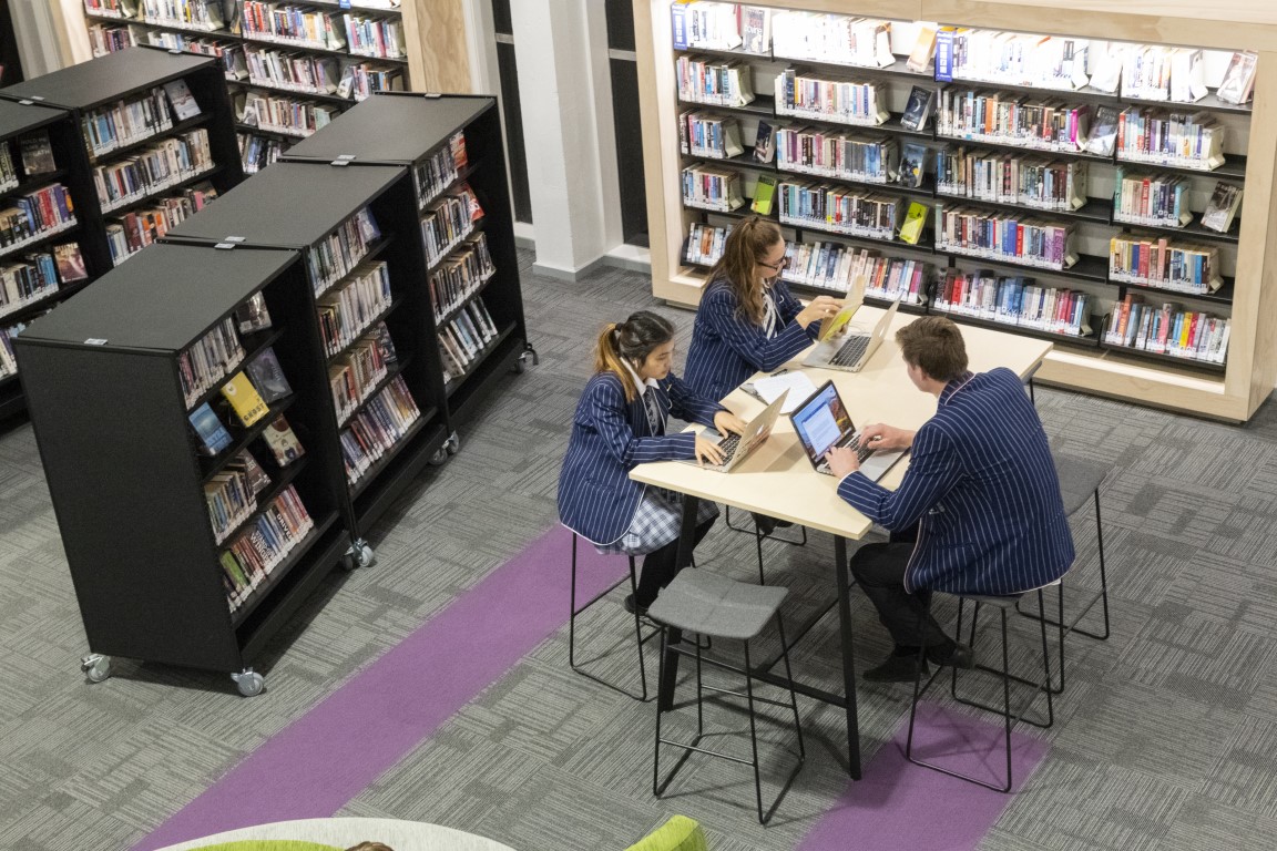 Students sat at desk in Green Library and Innovation Centre on laptops