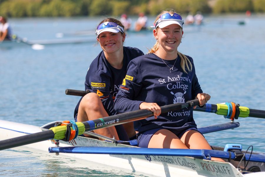 Two St Andrew's College female rowers smiling