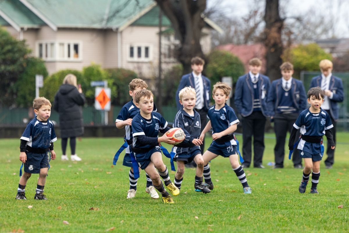 A group of St Andrew's College Preparatory School students playing rugby.