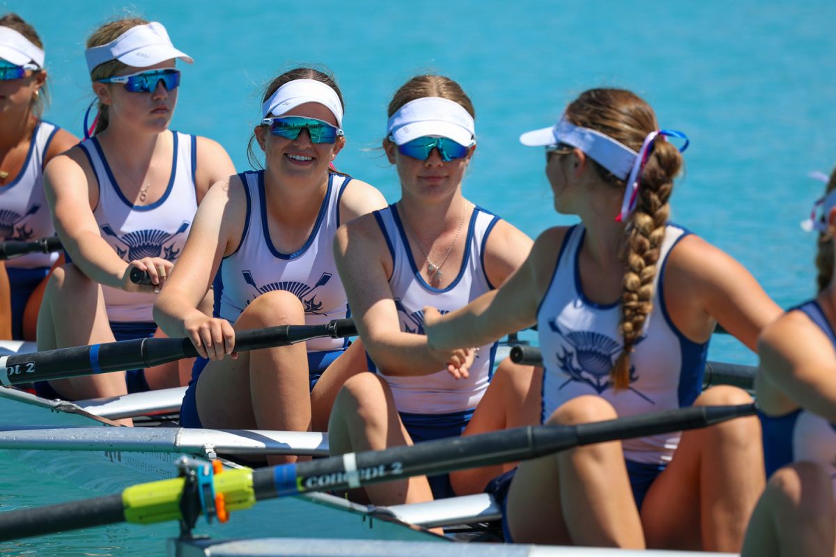 A group of St Andrew's College Secondary School students rowing.