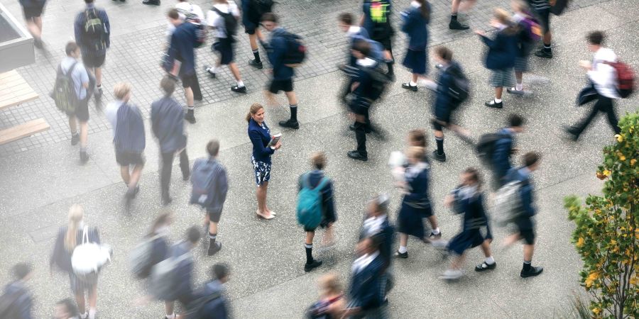 Aerial shot of teacher surrounded by teenagers