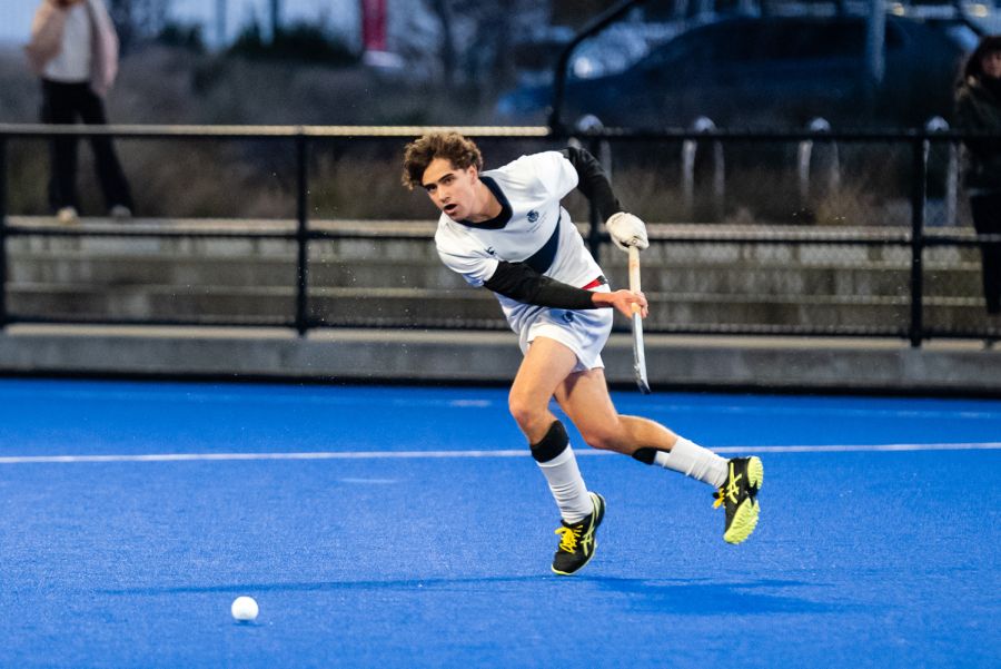 St Andrew's College student playing hockey