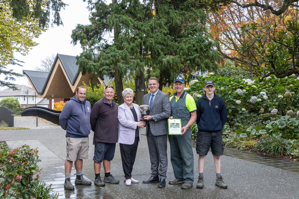 St Andrew's College Rector and Grounds team with Jan McFedries.