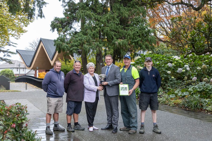 St Andrew's College Rector and Grounds team with Jan McFedries.