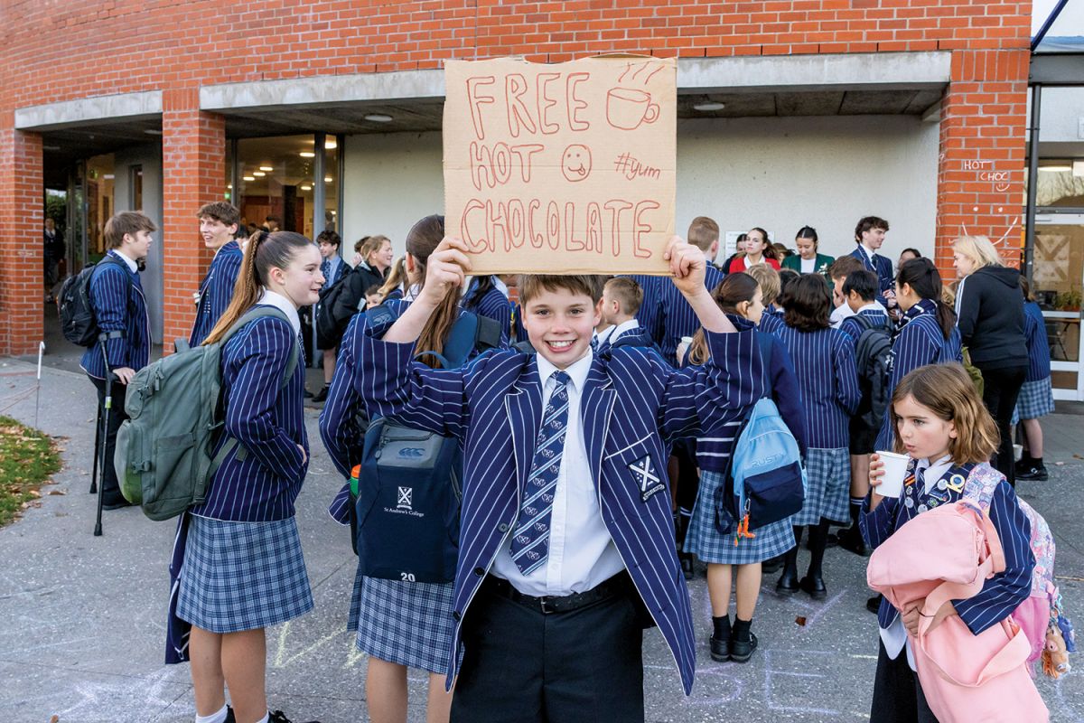 St Andrew's College student holding a sign that says 