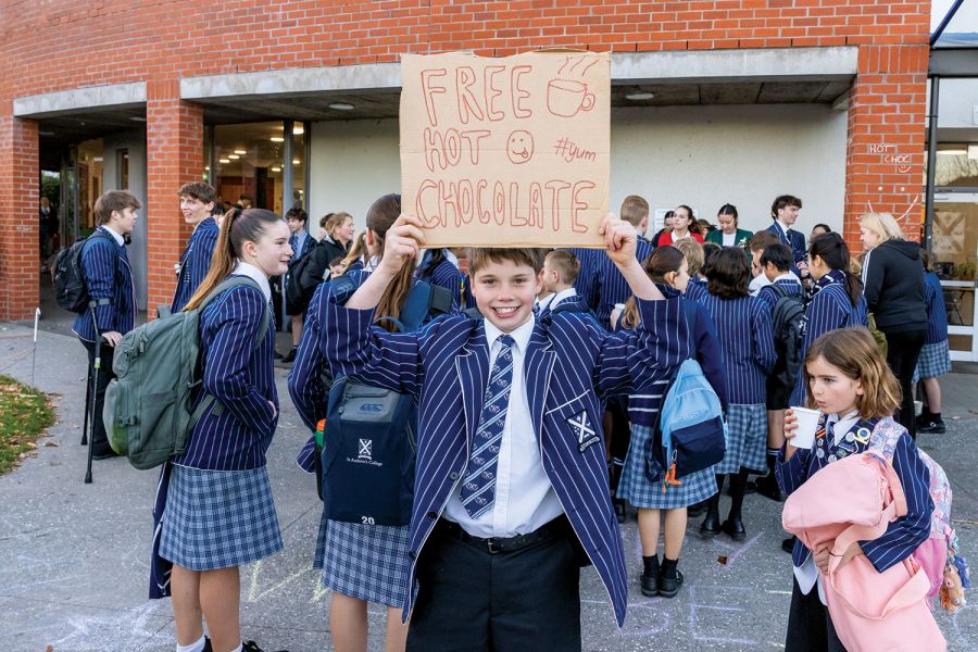 St Andrew's College student holding a sign that says 