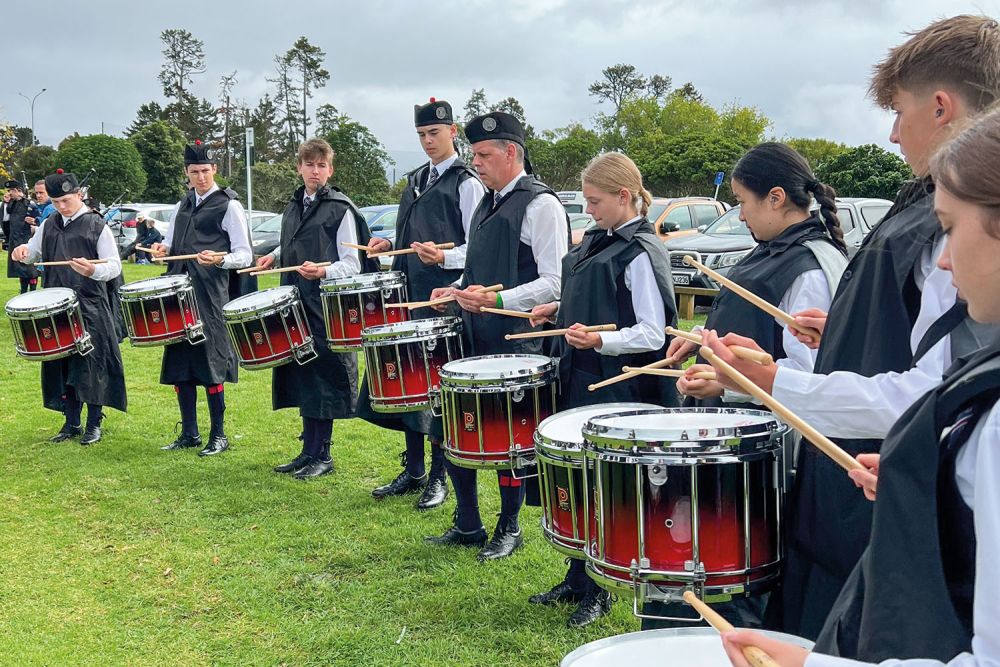 St Andrew's College Pipe Band members and staff at the 2024 New Zealand Pipe Band Championships.