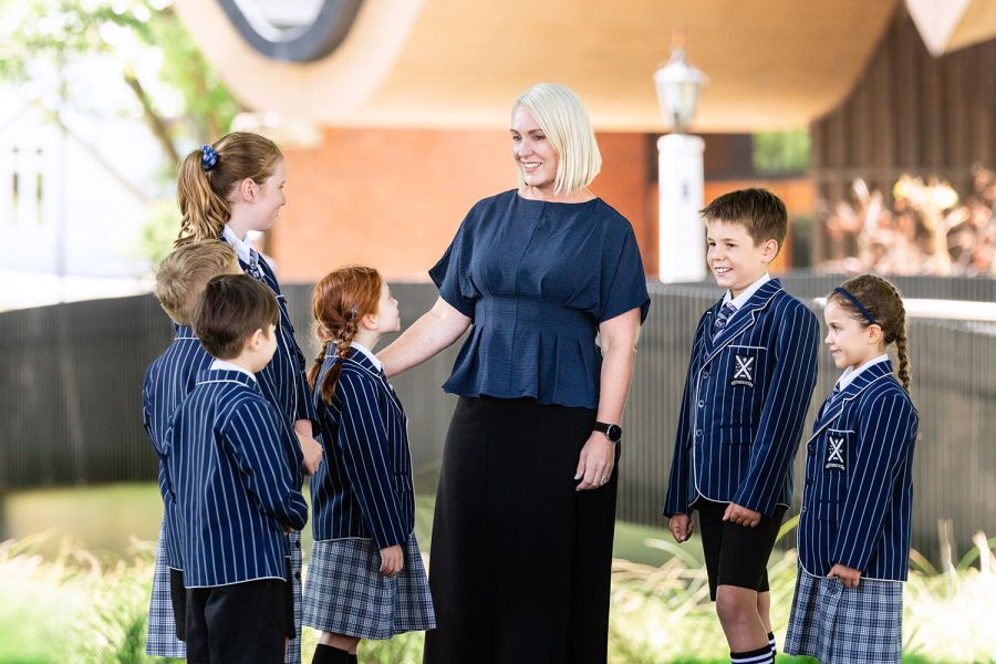 Principal of the St Andrew's College Preparatory School, Leigh Fowler, with six students.