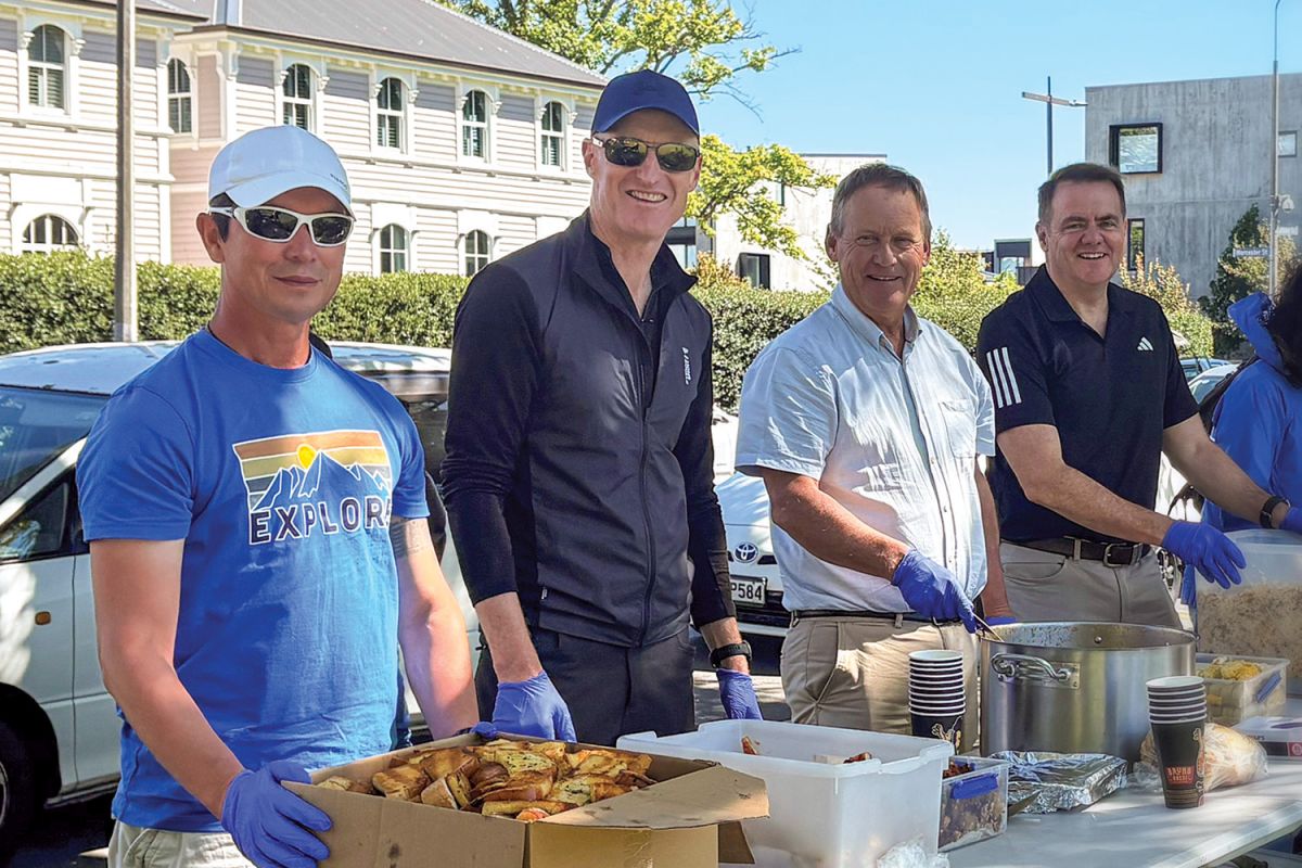 St Andrew's College staff members volunteering at a weekly community meal, providing free cooked meals for people experiencing homelessness or hardship.