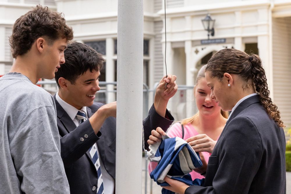 St Andrew's College students raising the flag at the 2026 Prefects’ Investiture and Leadership Assembly