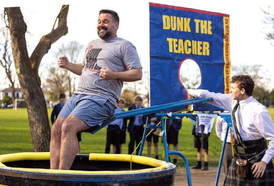 St Andrew's College student dunking Head of Middle School in water as part of a fundraiser for local charity.
