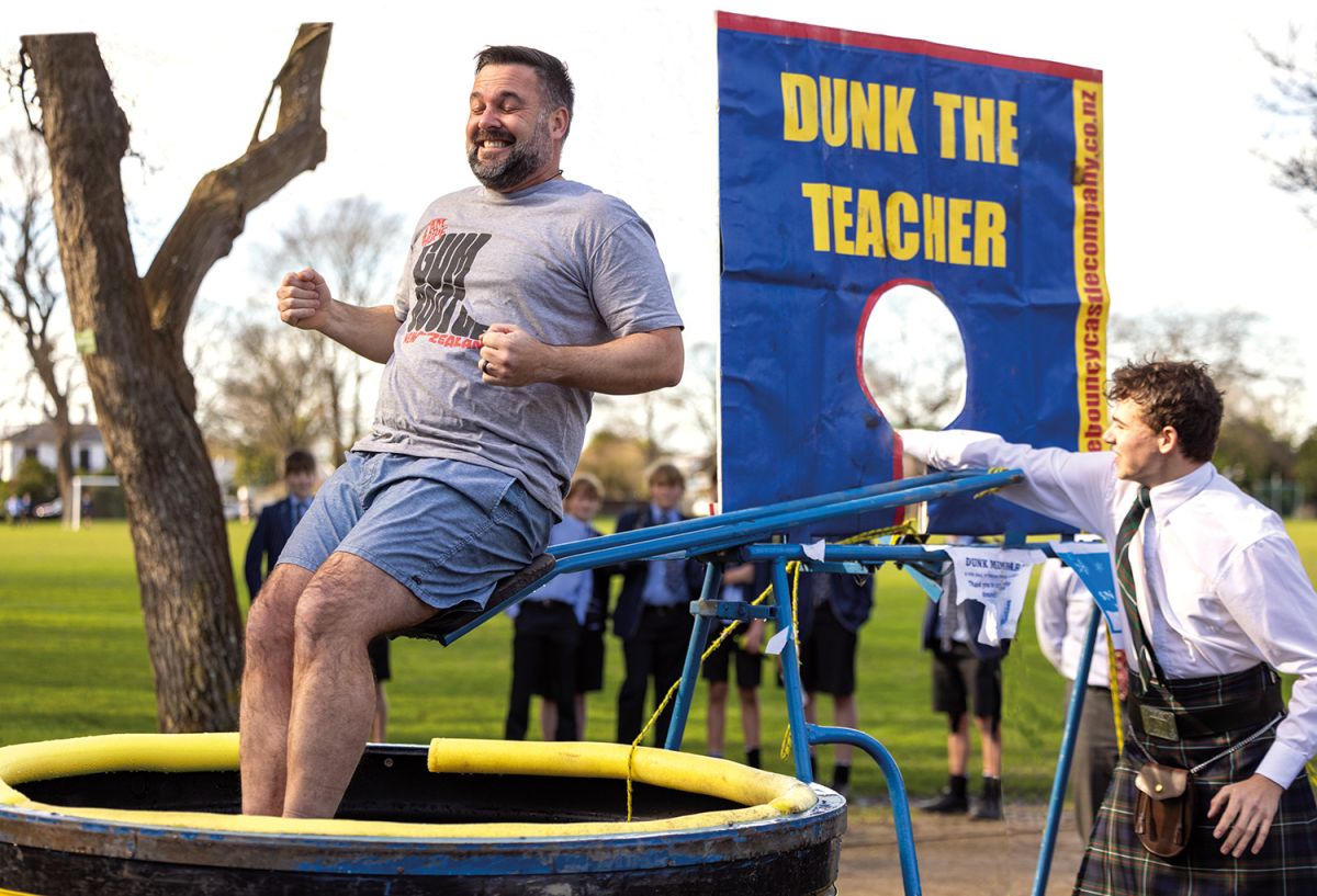 St Andrew's College student dunking Head of Middle School in water as part of a fundraiser for local charity.