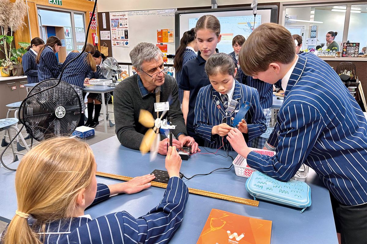 Four St Andrew's College students and a teacher during a Preparatory School science class.