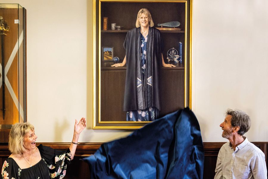 St Andrew's College Rector Christine Leighton and artist Neil Driver unveiling her portrait.
