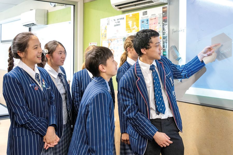 St Andrew's College student Aaron Moore presenting to students during a Science Club session.