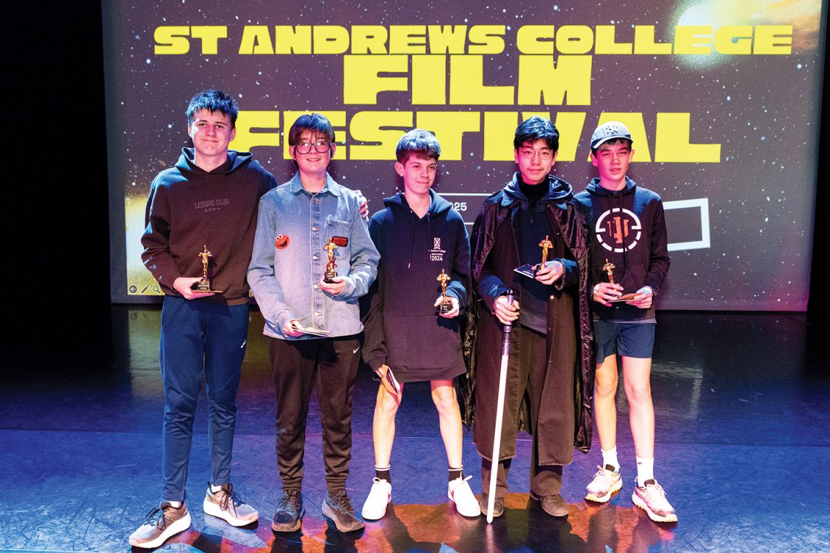 Five St Andrew's College students holding awards on stage at FilmFest 2025.