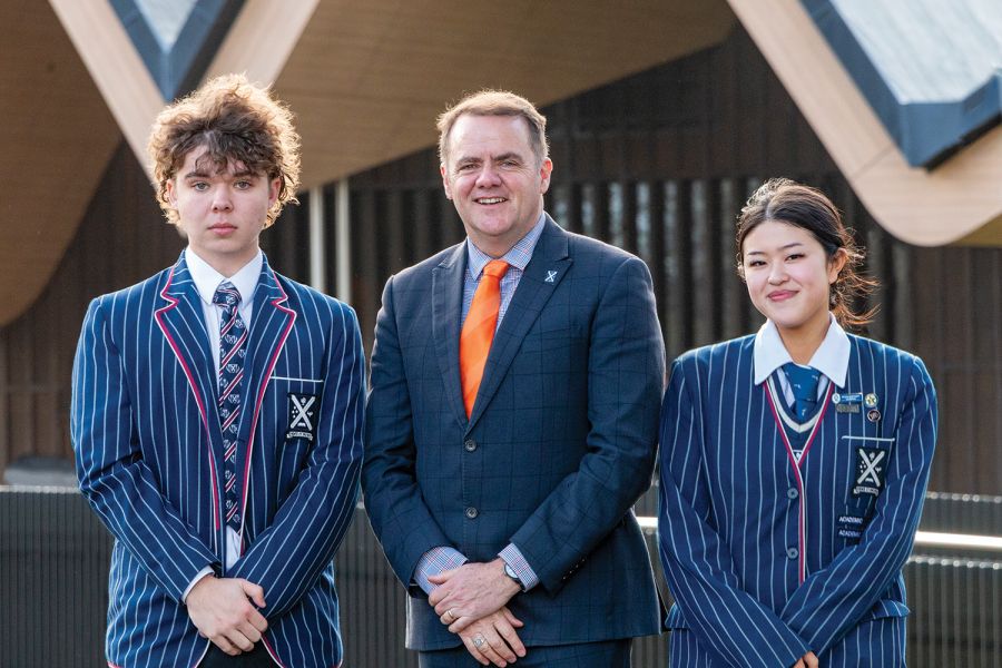 St Andrew's College Rector Mark Wilson, with students Thomas Palmer and Penny Dai.