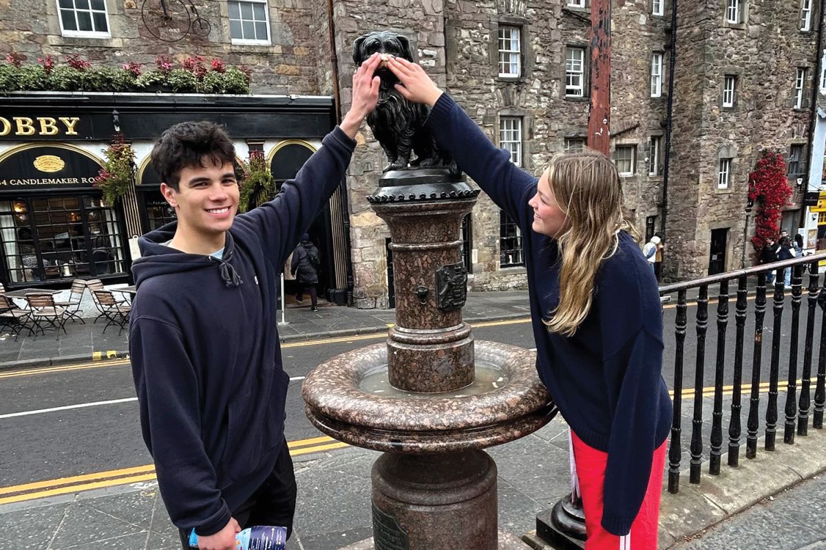 St Andrew's College Robert Burns scholars Tom Simpson and Lila Waghorn at the statue of Greyfriars Bobby in Edinburgh, Scotland.