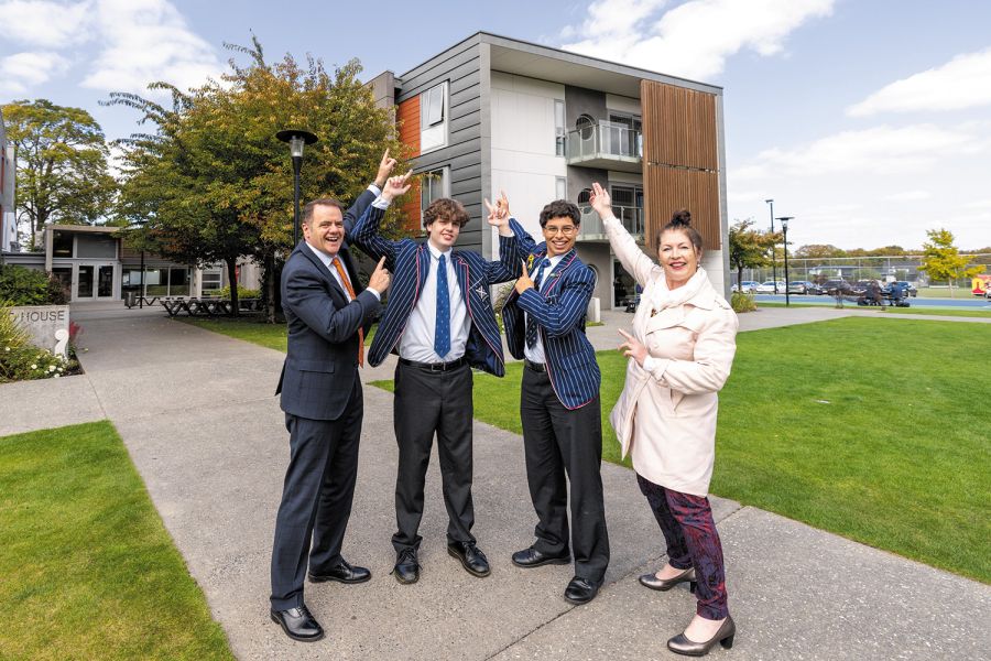 Rector, Mark Wilson, Heads of Sustainability Council, Theodore Meek and Daniel Officer, and Teacher in Charge of Sustainability Council, Ellen Hampson, pointing where the solar panels will be installed.