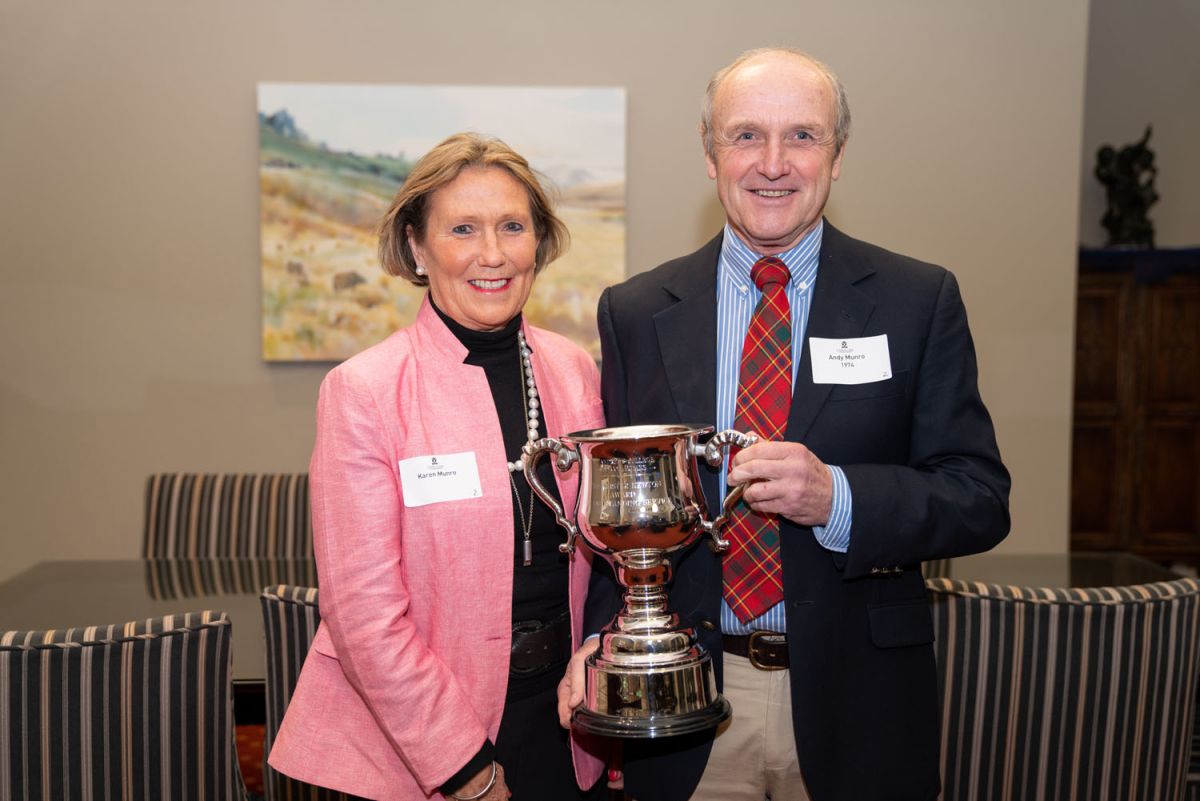 Andy Munro (OC 1974) with his wife Karen and holding the The Alister Newton Service award