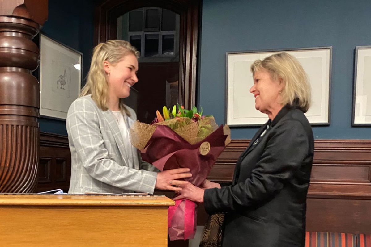 OCA President Meg Black (OC 2010) receives a bouquet from Rector Christine Leighton