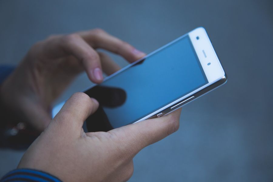Hands holding mobile phone