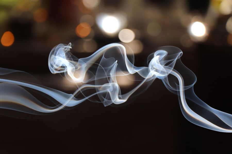 Smoke with lights in the background.