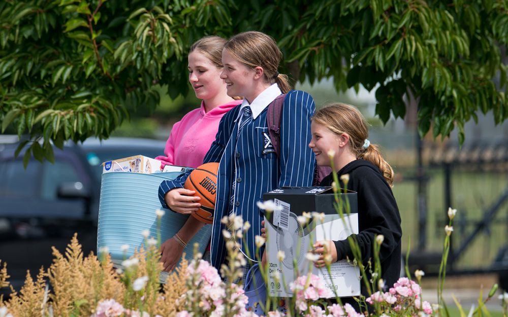 Boarder and siblings arriving with belongings.